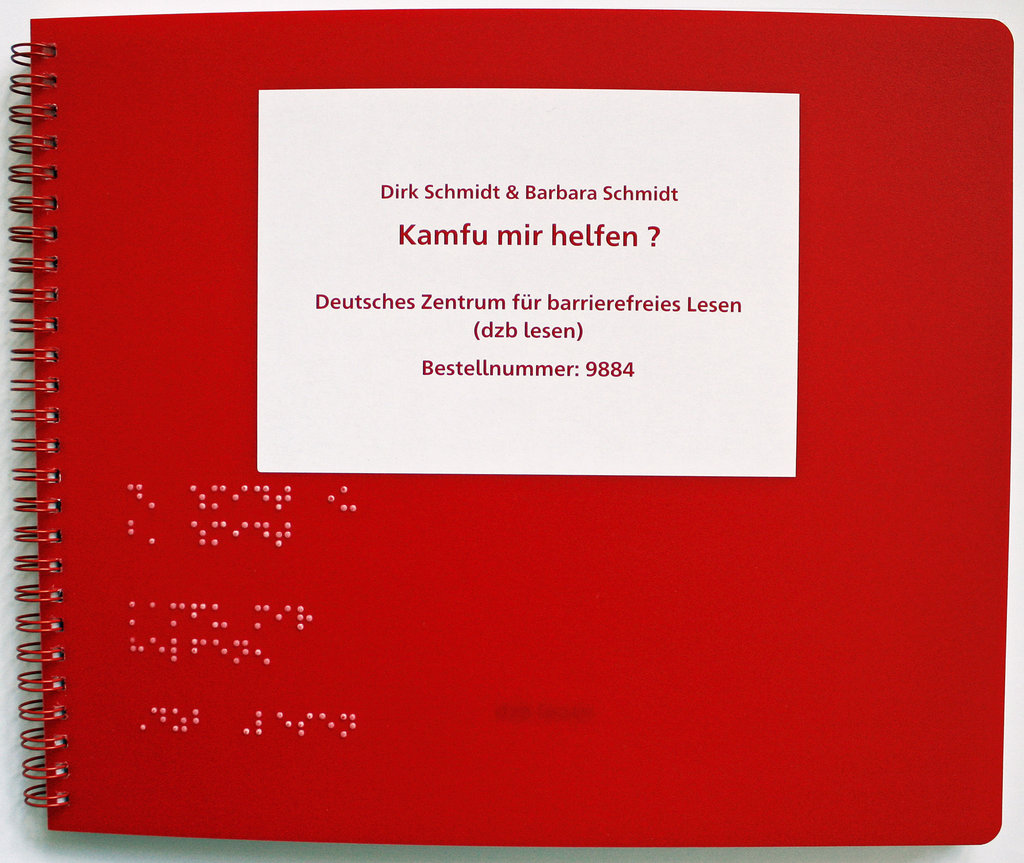 Cover des Buches, Ringbindung, roter Kunststoffeinband, Text in Brailleschrift und Schwarzschrift