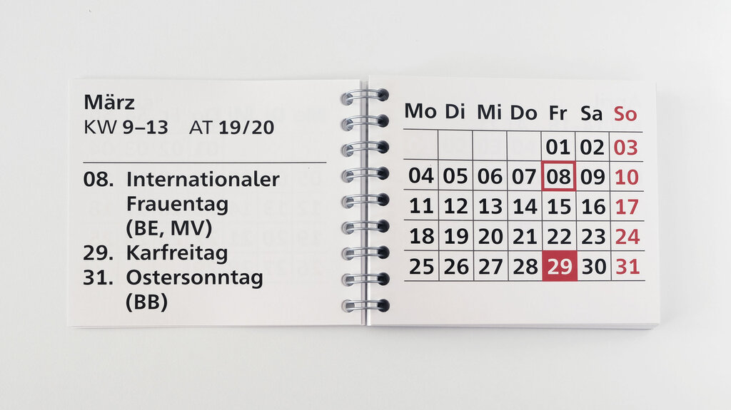 Aufgeschlagener Großdruck-Taschenkalender mit Monatsübersicht und Feiertagen