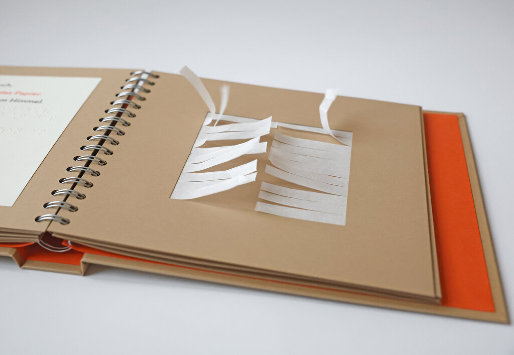 Buch mit feinen Papierstreifen zum Anpusten, die ein raschelndes Windgeräusch erzeugen.